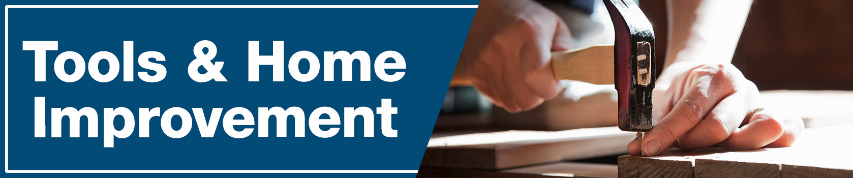 Hands holding a hammer and nail above a piece of wood