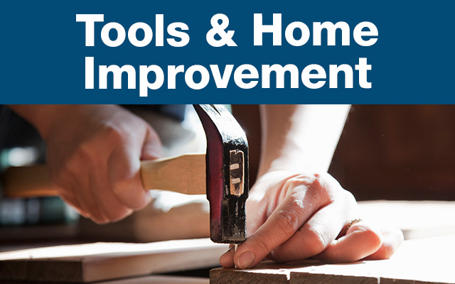 Hands holding a hammer and nail above a piece of wood