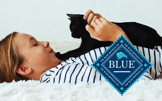 Girl with black kitten and Blue Buffalo logo
